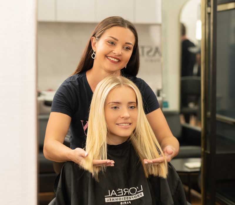 woman smiling after cutting her hair in brisbane salon